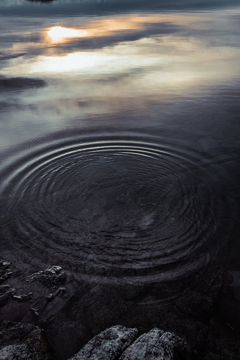 A tranquil scene of water ripples at sunset in San Carlos de Bariloche, Argentina.